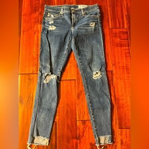 Woman’s AG jeans straight leg cropped. Medium washed. Distressed with rips